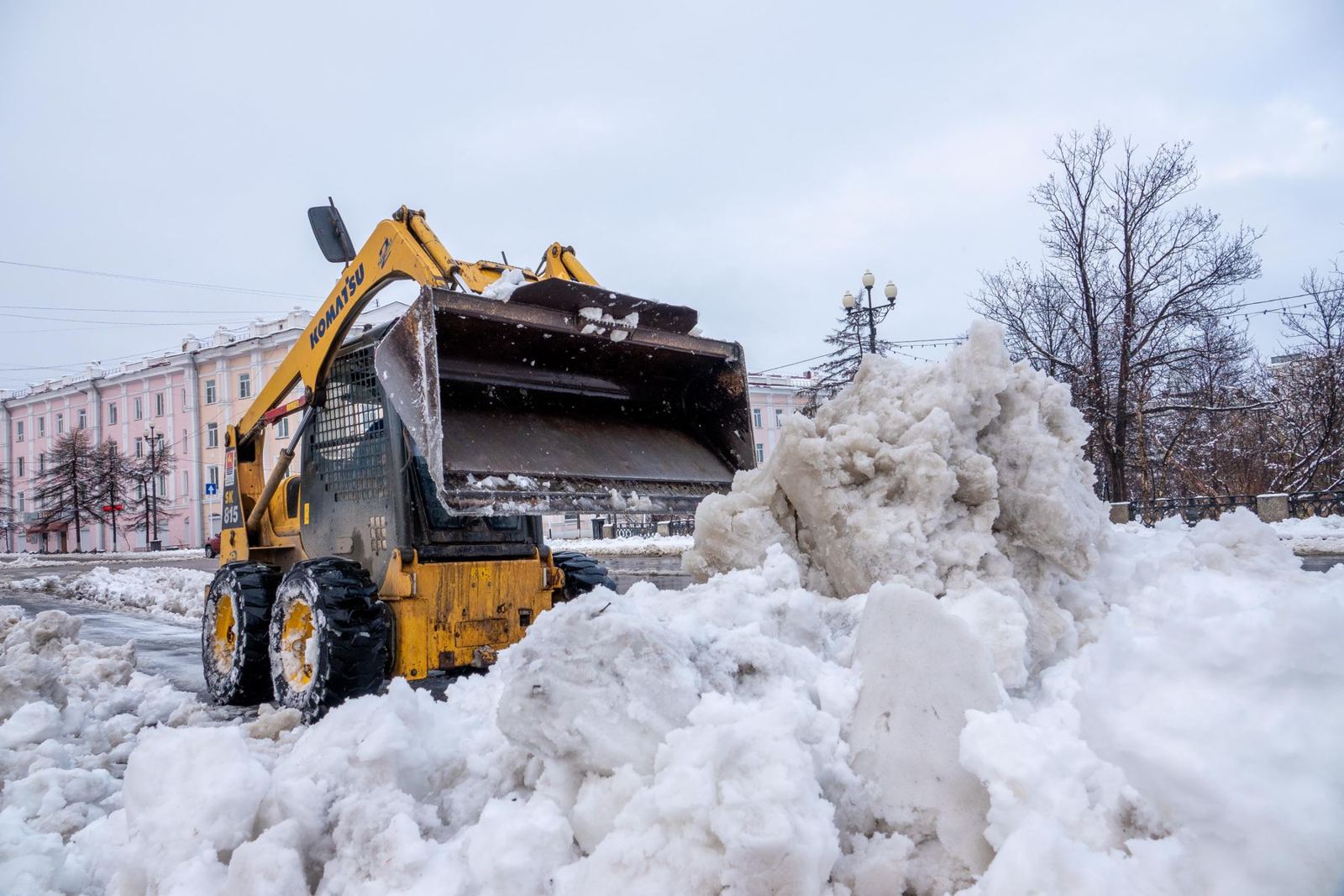 Loader clearing a big pile of snow